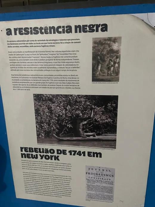 Painel A Resistência Negra, com gravuras de um líder quilombola jamaicano e de um homem numa canoa